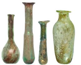 ROMA. Imperio Romano. Lote de cuatro ungüentarios (I-III d.C.). Vidrio. Altura 7,3-12,0 cm. Presentan irisaciones y exfoliaciones. 