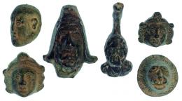 ROMA. Imperio Romano. Lote de seis apliques (I-III d.C.). Bronce. 1 leontiforme, 2 con representación de Attis, figura masculina con gorro frigio y 2 con representación facial masculina. Altura 4,4 cm. Diámetro 2,0-2,4 cm.