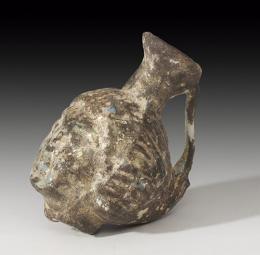 ROMA. Imperio Romano. Ungüentario o frasco en forma de cabeza humana (II-III d.C.). Vidrio. Altura 7,3 cm. Presenta irisaciones. 
