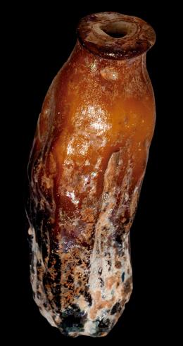 ARQUEOLOGÍA. ROMA. Imperio Romano. Ungüentario (I-II d.C.). Vidrio. En forma de dátil. Altura 7,4 cm. Presenta irisaciones y alteraciones cromáticas.
