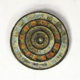 ROMA. Imperio Romano. Aplique con decoración polícroma (ss. III-IV d.C.). Bronce con esmalte. Restos de pegamento en el reverso. Diámetro 4,4 cm. 
