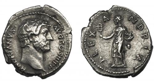 147 - ADRIANO. Denario. Roma (130-133 d.C.). R/ Alejandría con sistro y cuenco con serpiente; ALEXANDRIA. AR 3,12 g. 13,5 mm. RIC-1501. Limpiada. MBC.