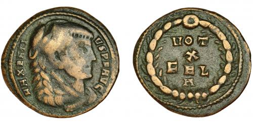 241 - MAJENCIO. Follis reducido. Aquileia (310). R/ Corona rodeando VOT/X/FEL/A. AE 2,80 g. 20 mm. RIC-128? BC+/MBC. Rarísima.