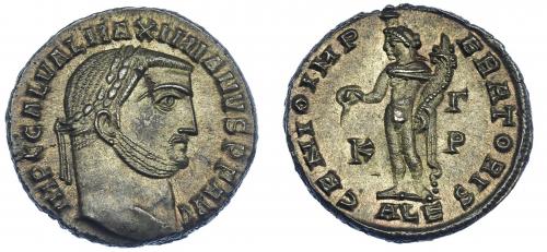 227 - IMPERIO ROMANO. GALERIO MAXIMIANO. Follis. Alejandría (308-310). R/ Genio a izq. con pátera y cornucopia; GENIO IMPERATORIS, en campo K-G /P. AE 6,62 g. 23,2 mm. RIC-107a. Hojita en rev. P.O. EBC/EBC+.