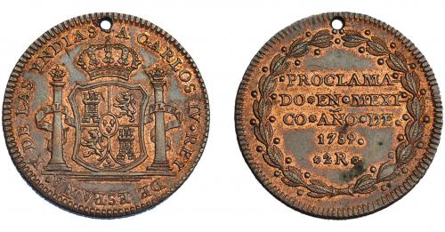 3273 - CARLOS IV. Medalla de proclamación con valor 2 reales. 1789. México. AE 28 mm. H-163 vte. R.B.O. Agujero. EBC. Muy escasa.