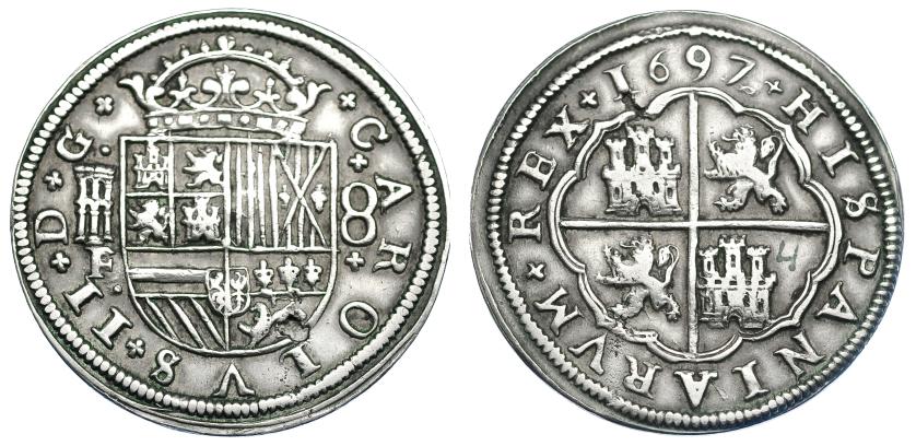 1065   -  CARLOS II. 8 reales. 1697 sobre 82. Segovia F sobre otro ensayador, posiblemente BR. AC-771. Dos pequeñas erosiones por metal mal batido. MBC. Muy escasa.