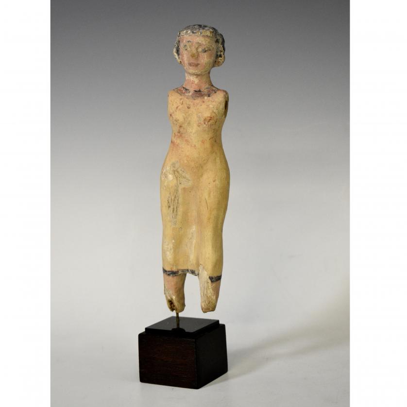 2002   -  ANTIGUO EGIPTO. Estatuilla femenina, con vestido largo y peluca nubia. Imperio Medio (c. 2050-1750 a. C.). Madera con estuco policromado. Altura 19 cm. Ex Malter Gallery (Estados Unidos).